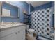 Cozy bathroom featuring a floral shower curtain, grey countertop, and framed mirror at 2721 Greenleaf Ter, Parrish, FL 34219