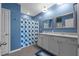 Bathroom showcasing double sinks and a shower with blue flower curtain at 2721 Greenleaf Ter, Parrish, FL 34219