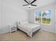 Cozy bedroom with carpet, ceiling fan, and a window overlooking the exterior at 2721 Greenleaf Ter, Parrish, FL 34219