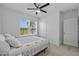 Bright bedroom with carpet, ceiling fan, and a window overlooking the exterior at 2721 Greenleaf Ter, Parrish, FL 34219
