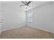 Neutral bedroom with a ceiling fan and a window, offering a calming space at 2721 Greenleaf Ter, Parrish, FL 34219