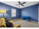 Stylish bedroom with a vibrant blue accent wall, desk, and a comfortable sofa at 2721 Greenleaf Ter, Parrish, FL 34219