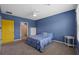 This bedroom features carpeted floors, a yellow door, and access to the bathroom at 2721 Greenleaf Ter, Parrish, FL 34219