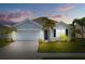 Charming single-story home featuring a two-car garage, well-manicured lawn and tropical landscaping at 2721 Greenleaf Ter, Parrish, FL 34219