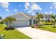 Charming single-story home with a two-car garage, manicured lawn, and lush landscaping at 2721 Greenleaf Ter, Parrish, FL 34219