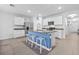 Bright kitchen features white cabinets, granite countertops, stainless steel appliances and a blue breakfast bar at 2721 Greenleaf Ter, Parrish, FL 34219