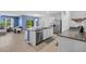 Modern kitchen featuring an island with a stainless steel sink and views into the living area at 2721 Greenleaf Ter, Parrish, FL 34219