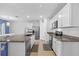Contemporary kitchen with a granite countertop island, stainless steel appliances, and white cabinets at 2721 Greenleaf Ter, Parrish, FL 34219