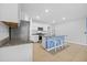 Bright kitchen features white cabinets, granite countertops, stainless steel appliances and a blue breakfast bar at 2721 Greenleaf Ter, Parrish, FL 34219