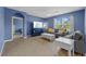 Bright blue living room with gray couches, a ceiling fan, and an abundance of natural light at 2721 Greenleaf Ter, Parrish, FL 34219