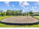 Community playground featuring swings, slides, and benches on a wood chip base at 2721 Greenleaf Ter, Parrish, FL 34219