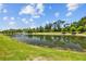 Scenic view of the community pond with fountain and lush landscaping surrounding it at 2721 Greenleaf Ter, Parrish, FL 34219