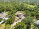 Beautiful aerial view of home surrounded by lush greenery and mature trees at 296 Pine Ranch Trl, Osprey, FL 34229