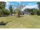 Expansive backyard showcasing the screened-in lanai and lush greenery at 296 Pine Ranch Trl, Osprey, FL 34229