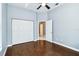 This bedroom has hardwood floors, a ceiling fan, a closet, and a connecting door at 296 Pine Ranch Trl, Osprey, FL 34229