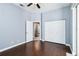 This bedroom has hardwood floors, a ceiling fan, a closet, and a connecting door at 296 Pine Ranch Trl, Osprey, FL 34229