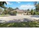 Exterior of a home showing a large driveway, garage, and yard at 296 Pine Ranch Trl, Osprey, FL 34229
