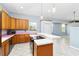Kitchen with wood cabinets, stainless steel appliances, and a tiled breakfast bar at 296 Pine Ranch Trl, Osprey, FL 34229