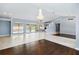 Spacious living room with beautiful floors, large windows, and a chandelier at 296 Pine Ranch Trl, Osprey, FL 34229