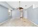 Spacious living room featuring tile floors and a modern ceiling fan at 296 Pine Ranch Trl, Osprey, FL 34229