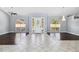 Spacious living room with beautiful floors, large windows, and a chandelier at 296 Pine Ranch Trl, Osprey, FL 34229