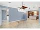 Living area with tile flooring adjacent to kitchen with wood cabinets and tile backsplash at 296 Pine Ranch Trl, Osprey, FL 34229