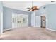 Bright main bedroom with sliding glass doors and white plantation shutters at 296 Pine Ranch Trl, Osprey, FL 34229