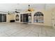 This screened-in lanai has stone floors, arched windows, and doors to the back yard at 296 Pine Ranch Trl, Osprey, FL 34229
