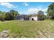 View of house and screened-in pool from the yard at 296 Pine Ranch Trl, Osprey, FL 34229