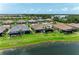 Aerial view features a lakefront home with lush landscaping and a screened-in lanai at 3027 Formia Ct, Lakewood Ranch, FL 34211