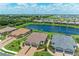 Aerial view showcases the home with a lake view, surrounded by lush greenery and other residences at 3027 Formia Ct, Lakewood Ranch, FL 34211