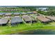 Aerial view of the home surrounded by well-maintained landscaping and overlooking a beautiful lake at 3027 Formia Ct, Lakewood Ranch, FL 34211