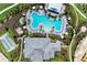 Aerial view of large community pool with lounge seating, umbrellas, and mature landscaping at 3027 Formia Ct, Lakewood Ranch, FL 34211