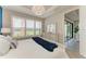 Bedroom featuring a bed with a blue accent blanket and large windows with white shutters at 3027 Formia Ct, Lakewood Ranch, FL 34211