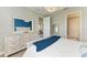 Primary bedroom with neutral tones, white trim, and a blue throw blanket at 3027 Formia Ct, Lakewood Ranch, FL 34211