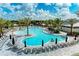 Large community pool surrounded by ample seating, palm trees, and shade umbrellas at 3027 Formia Ct, Lakewood Ranch, FL 34211