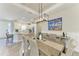Open concept dining room features an elegant light fixture with sightlines to the kitchen at 3027 Formia Ct, Lakewood Ranch, FL 34211