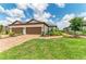 Charming exterior with two-car garage, red brick driveway and walkway, and meticulously maintained landscaping at 3027 Formia Ct, Lakewood Ranch, FL 34211
