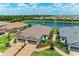 Aerial view of a home with a paver driveway, three-car garage, and lush landscaping at 3027 Formia Ct, Lakewood Ranch, FL 34211