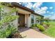 Inviting front entrance with brick walkway and blooming foliage in the landscaped garden at 3027 Formia Ct, Lakewood Ranch, FL 34211