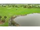 Scenic view of a golf course with a water hazard, showcasing lush green fairways at 3027 Formia Ct, Lakewood Ranch, FL 34211