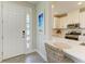 Bright, modern kitchen with stainless steel appliances and sleek white cabinetry and bar seating at 3027 Formia Ct, Lakewood Ranch, FL 34211