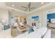 Open-concept living room with a tray ceiling and tile floors flows seamlessly into the kitchen at 3027 Formia Ct, Lakewood Ranch, FL 34211