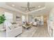 Open-concept living room with a tray ceiling and tile floors flows seamlessly into the kitchen at 3027 Formia Ct, Lakewood Ranch, FL 34211