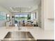 Open-concept living area with water views, comfortable seating, and seamless flow from kitchen island at 3027 Formia Ct, Lakewood Ranch, FL 34211