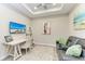 Comfortable office with beach-themed TV, horse artwork, cozy seating and a stylish ladder shelf for decor at 3027 Formia Ct, Lakewood Ranch, FL 34211