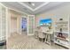 Well-lit office connected to bedroom and bathroom, featuring desk, ceiling fan and adjacent lounge seating at 3027 Formia Ct, Lakewood Ranch, FL 34211