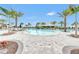 A sparkling pool with lounge chairs offers resort-style relaxation under palm trees at 3027 Formia Ct, Lakewood Ranch, FL 34211