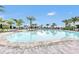 A sparkling pool with lounge chairs offers resort-style relaxation under palm trees at 3027 Formia Ct, Lakewood Ranch, FL 34211
