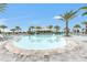 A sparkling pool with lounge chairs offers resort-style relaxation under palm trees at 3027 Formia Ct, Lakewood Ranch, FL 34211